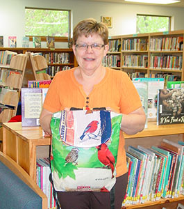 Dorchester Library director Sue Bedroske with Birding Backpack